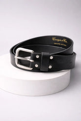 Brown leather belt with silver buckle on a white stand against a light gray background