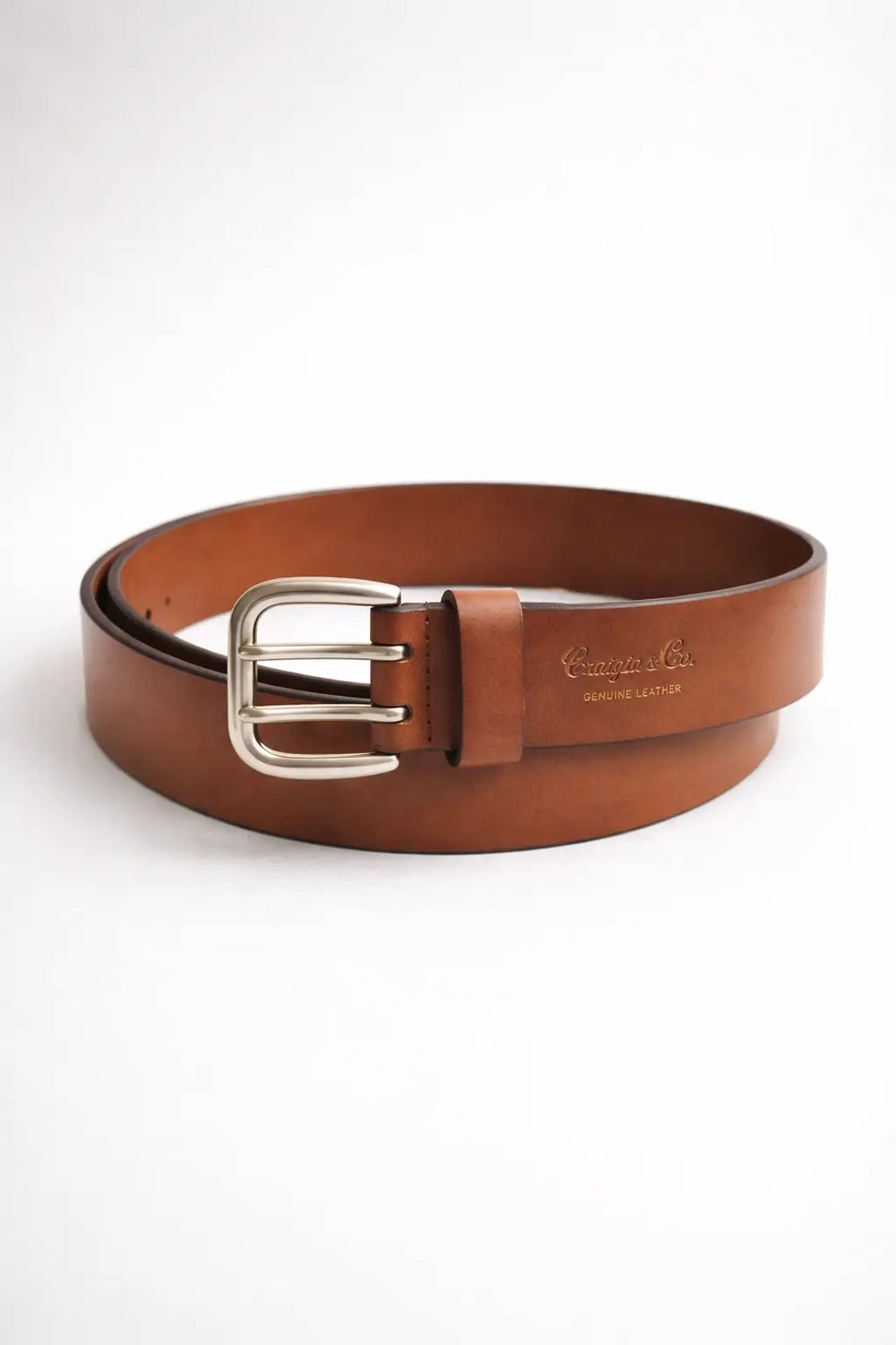 Brown leather belt with silver buckle on a white background
